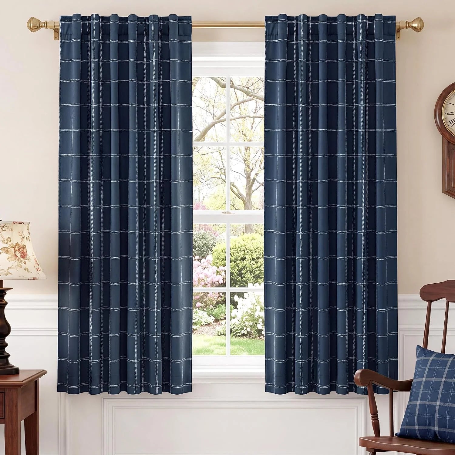 Navy windowpane plaid curtains with rod pocket hanging over a bright window