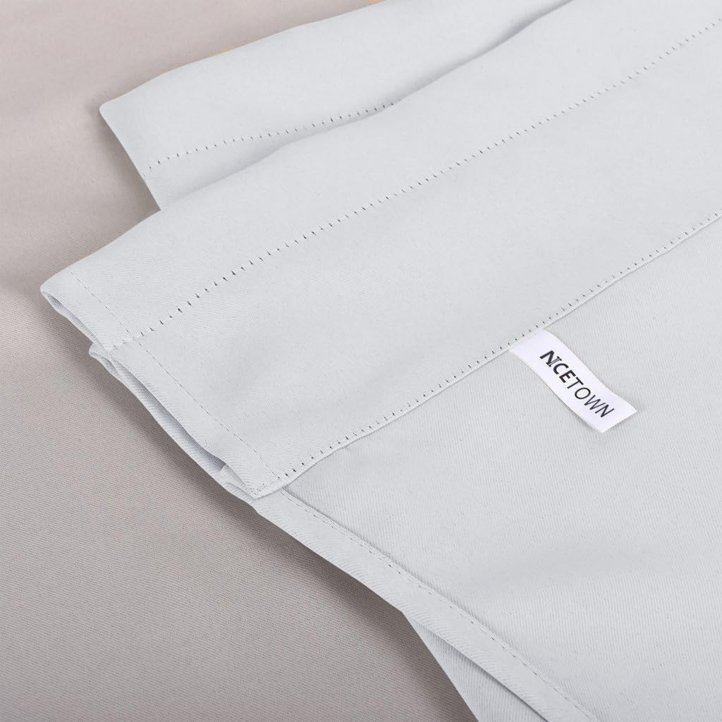 Close-up of a light grey NCETOWN curtain showing the top edge with a stitched rod pocket header and smooth fabric.