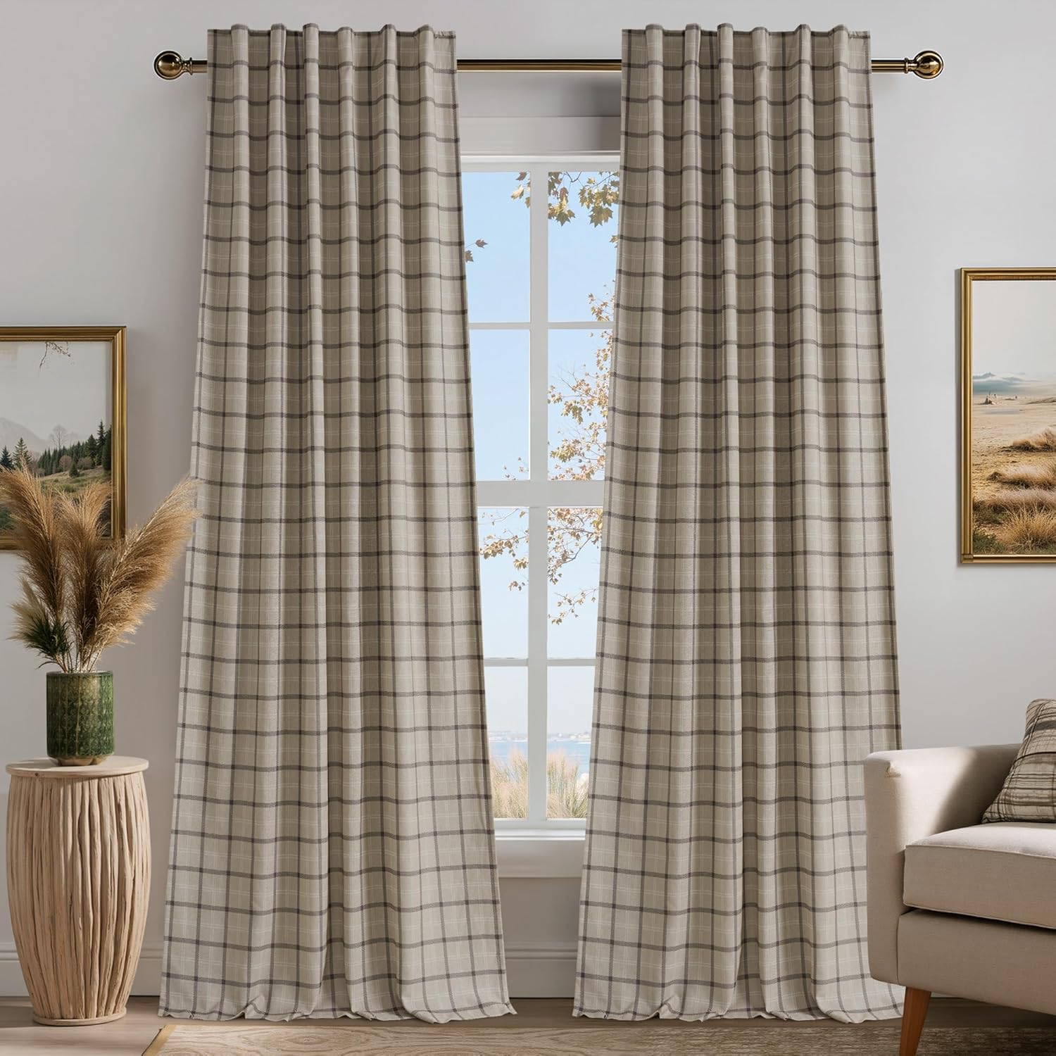 Pair of neutral beige and gray plaid back tab curtains on a gold rod, showing woven textured fabric.