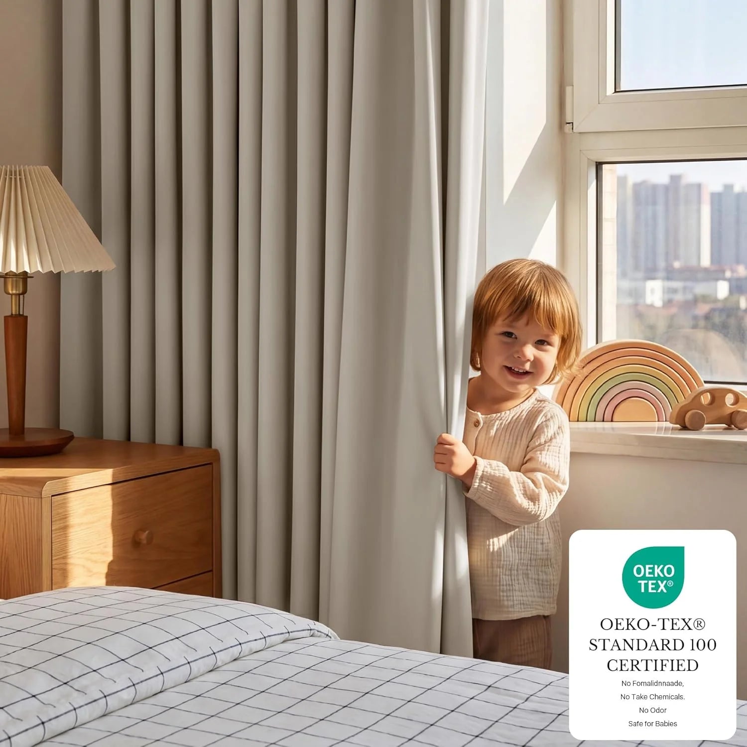 Smiling toddler peeking from behind light gray Oeko-Tex certified curtains in a bright bedroom.