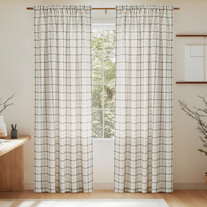 Pair of off-white and brown plaid rod pocket curtains on a wooden rod.