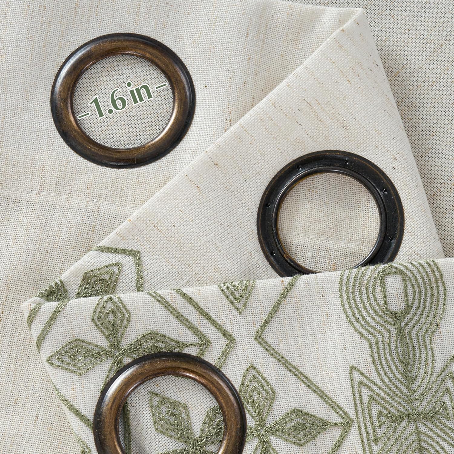 Off-white linen look curtain with dark bronze 1.6-inch grommets and green geometric embroidery.