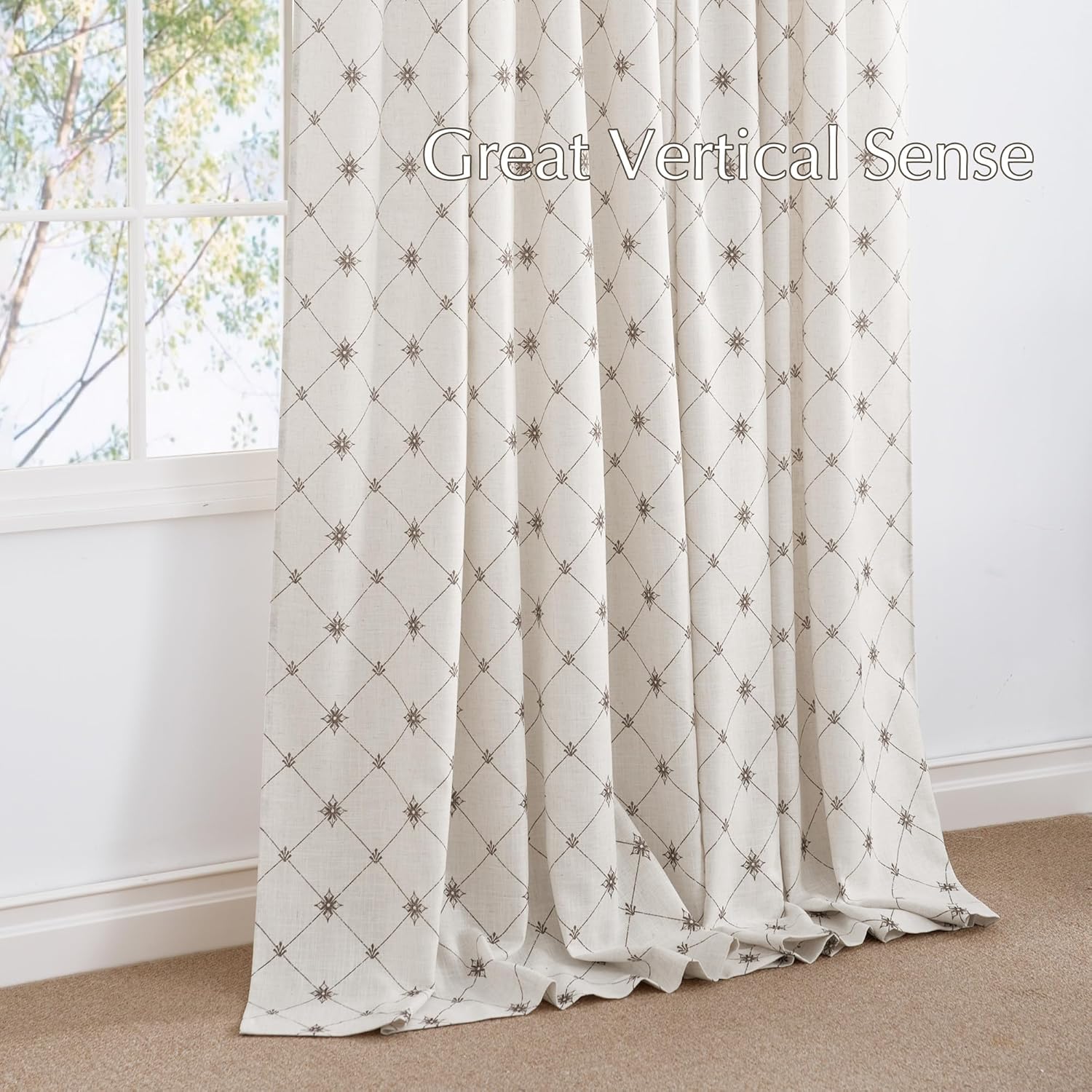 Off-white linen curtain with dark brown embroidered lattice pattern and starburst motifs, draped by a window.