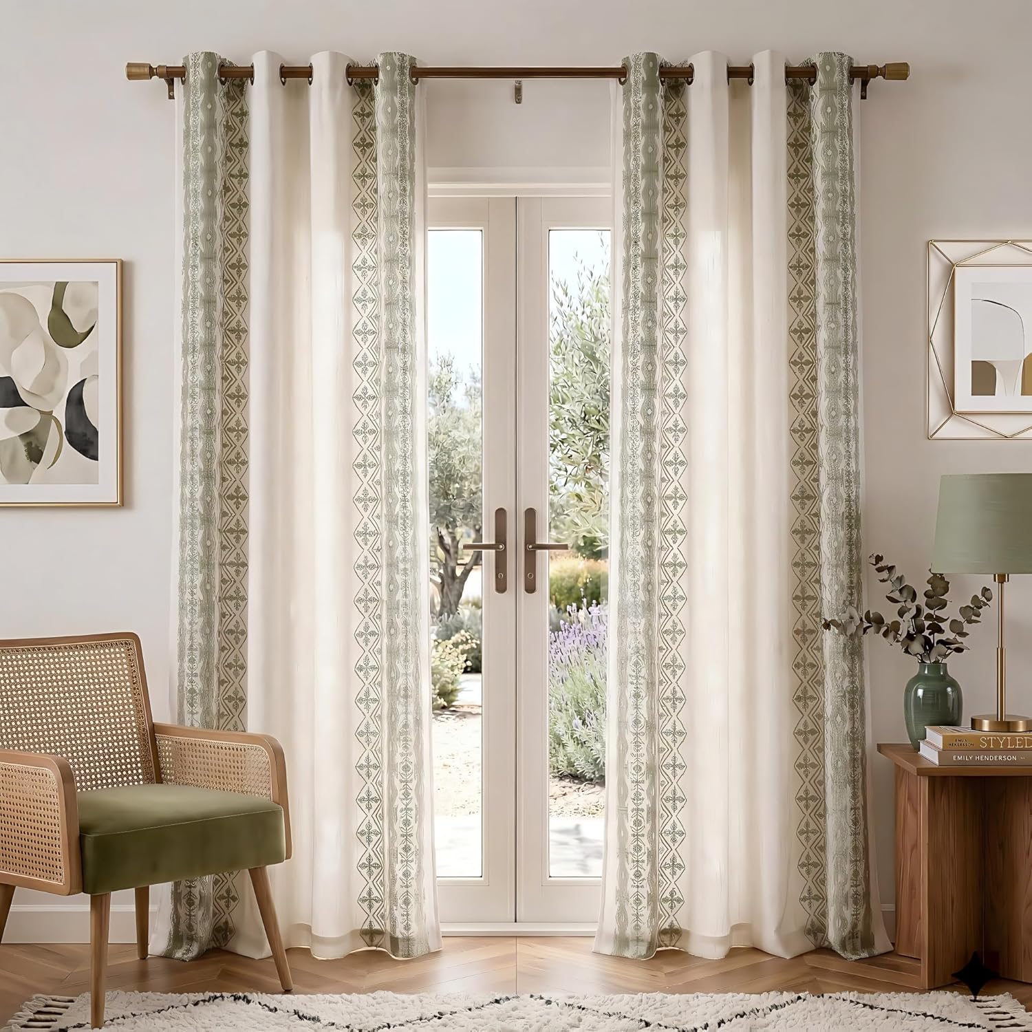 Off-white grommet top curtains with vertical sage green geometric embroidered borders over french doors.