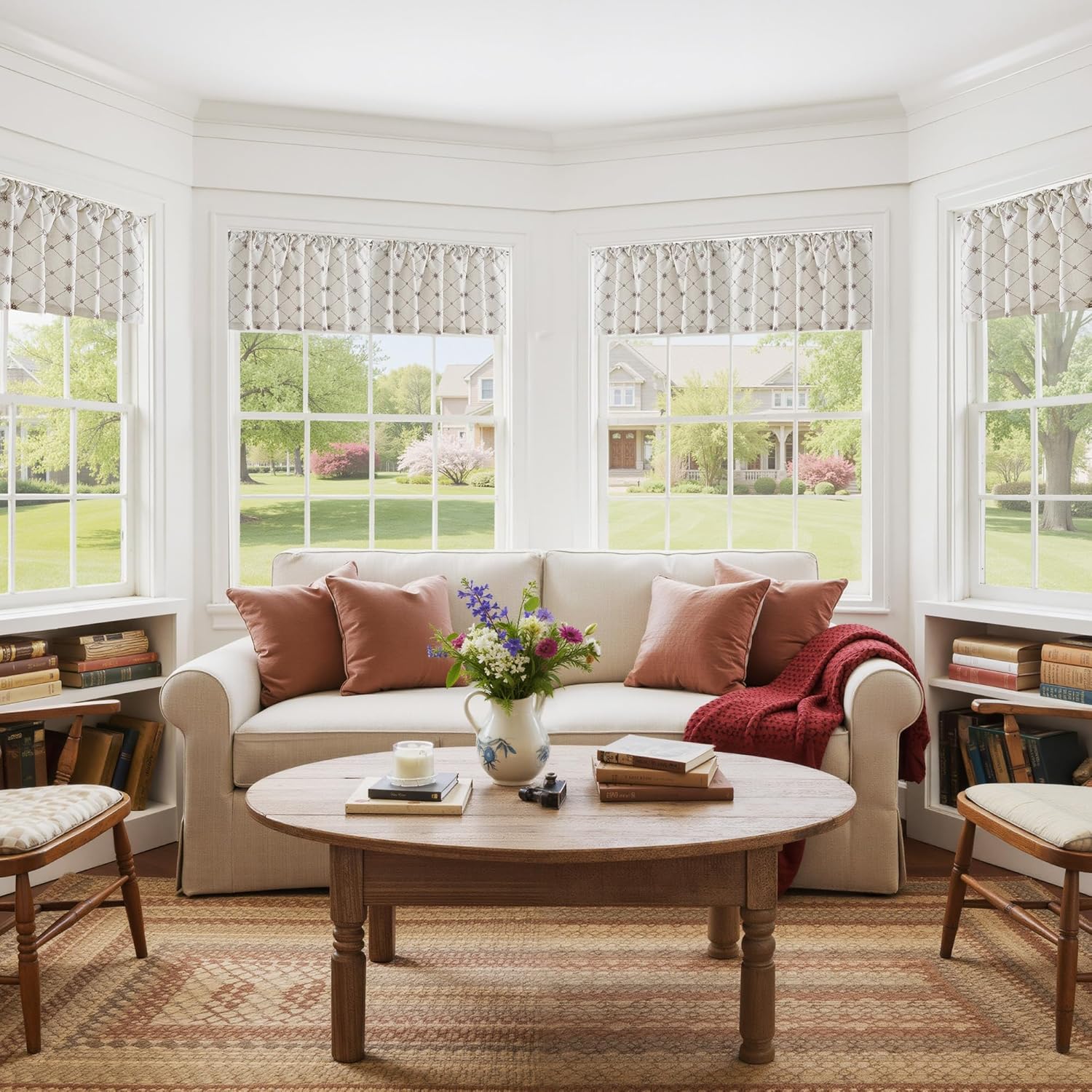 Off-white valance curtains with dark brown geometric diamond pattern, gathered above a bright bay window.