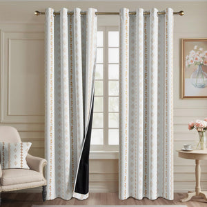 Off-white blackout curtains with golden geometric and floral patterns, featuring grommet top.