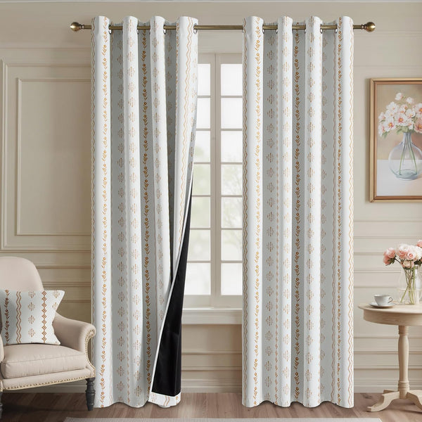 Off-white blackout curtains with golden geometric and floral patterns, featuring grommet top.