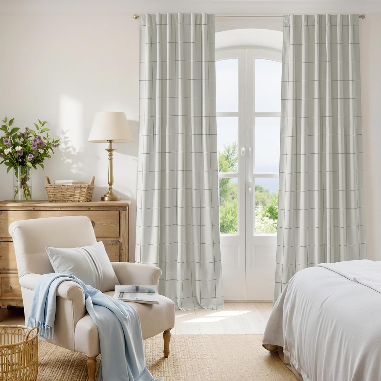 Pleated off-white window curtains with a minimalist black grid pattern, styled in a bright bedroom.