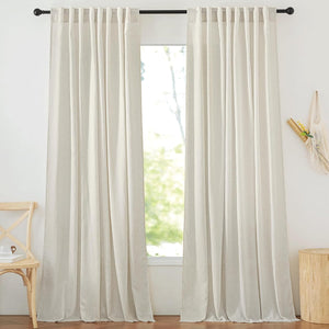 Pair of light beige linen back tab curtains with a natural texture hanging on a black rod.