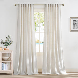Textured off-white linen blend back tab curtains softly draped at a window, filtering natural light.