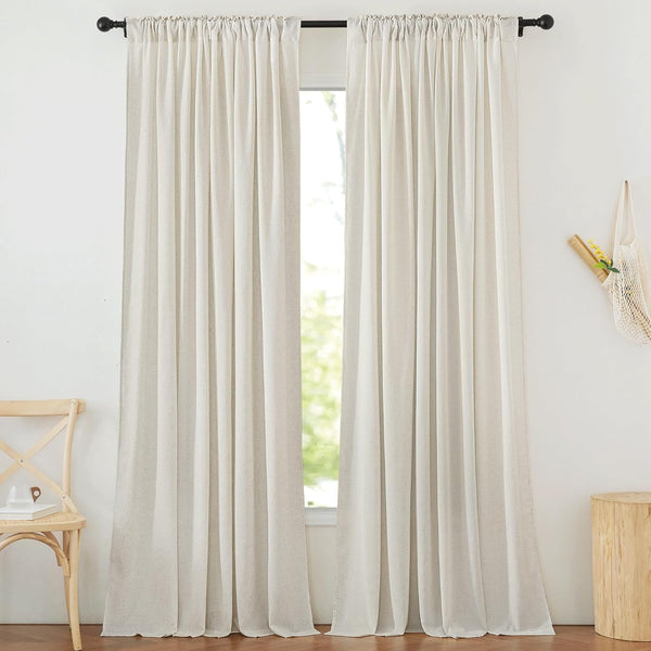Two off-white linen-textured rod pocket curtains on a black rod, filtering natural light.