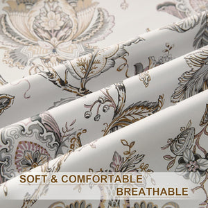 Close-up of off-white fabric with ornate floral damask pattern in muted grey, pink, and brown.