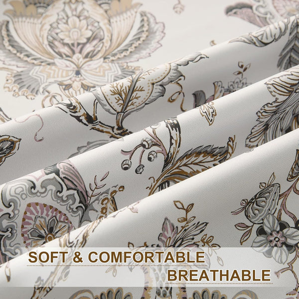 Close-up of off-white fabric with ornate floral damask pattern in muted grey, pink, and brown.