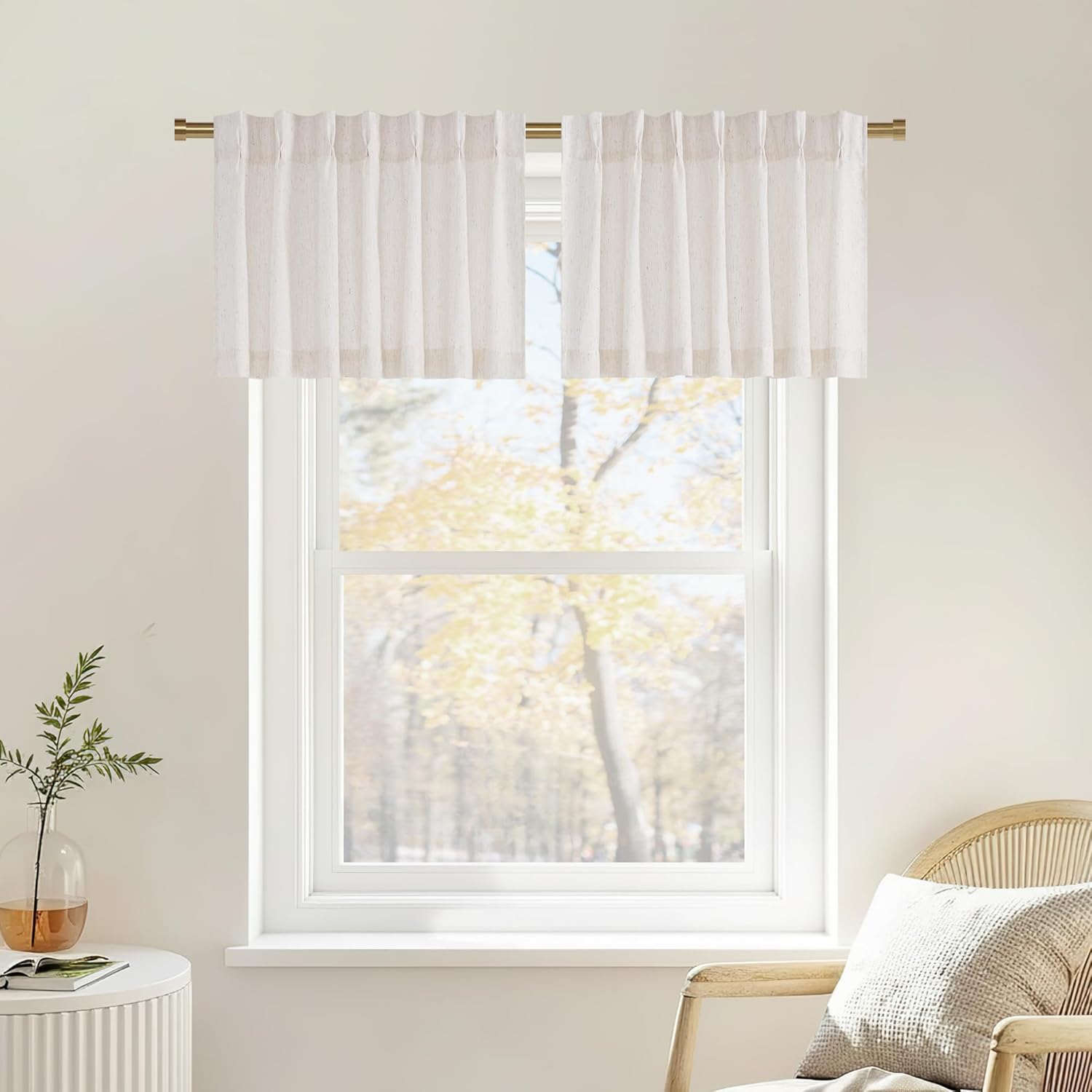Off-white textured cafe valance curtains with a pleated top, hung on a brass rod.