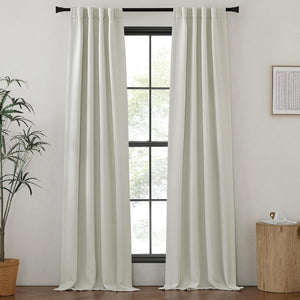 Pair of off-white textured linen-blend rod pocket curtains hanging on a black rod, framing a large window.