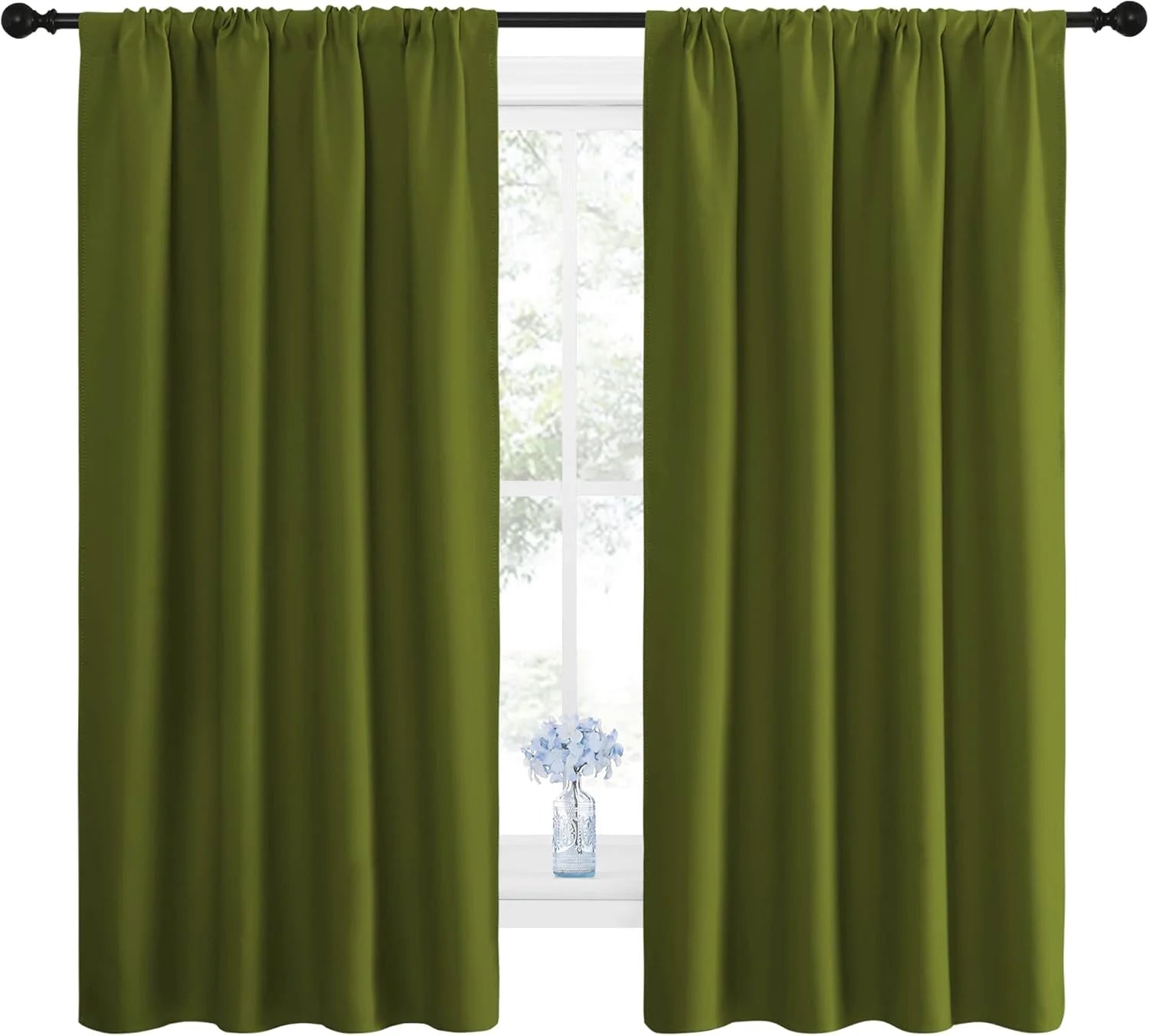 Olive green blackout curtains hanging on a black rod over a bright window