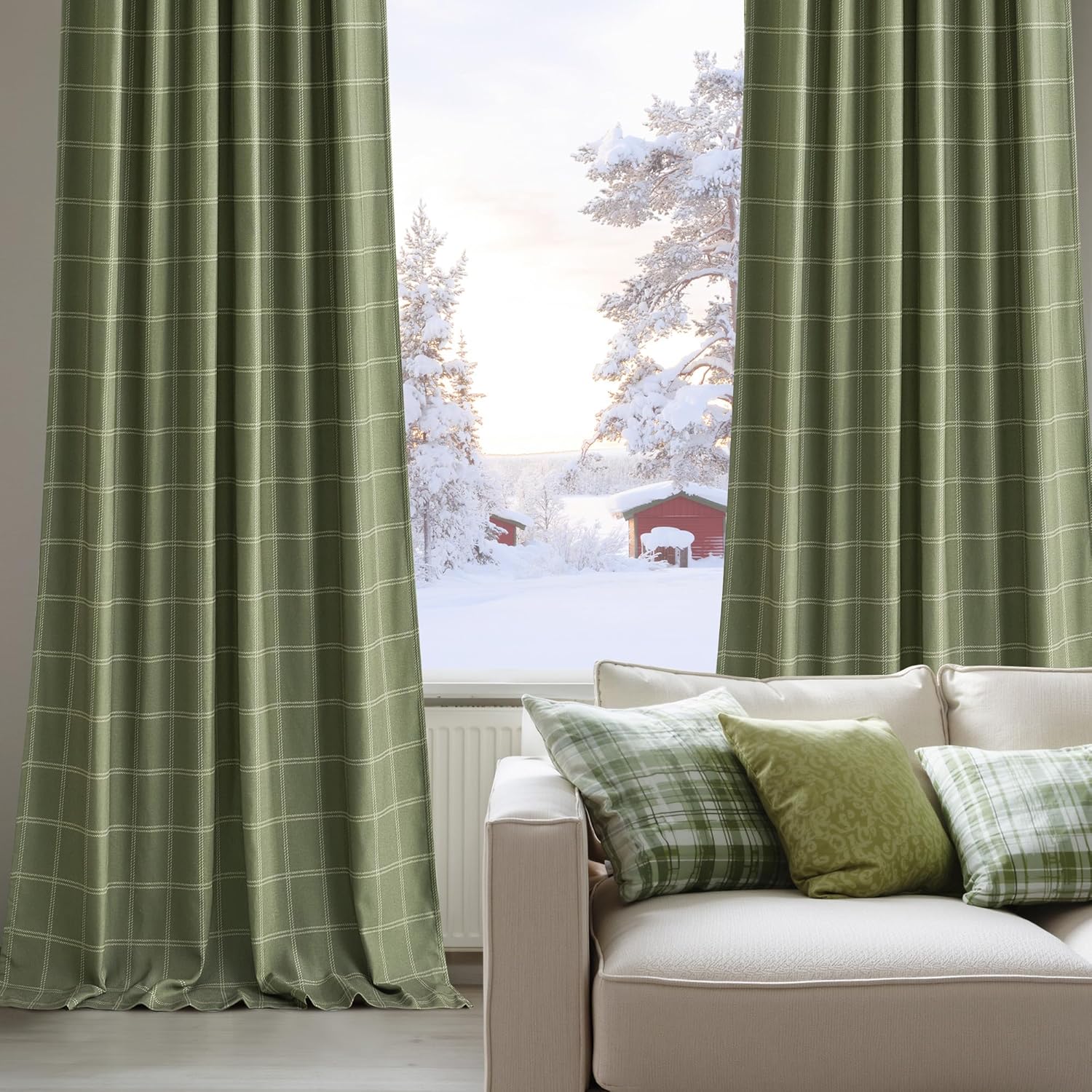 Olive green windowpane check curtains hanging in a room with a snowy view. Cream sofa and plaid cushions.