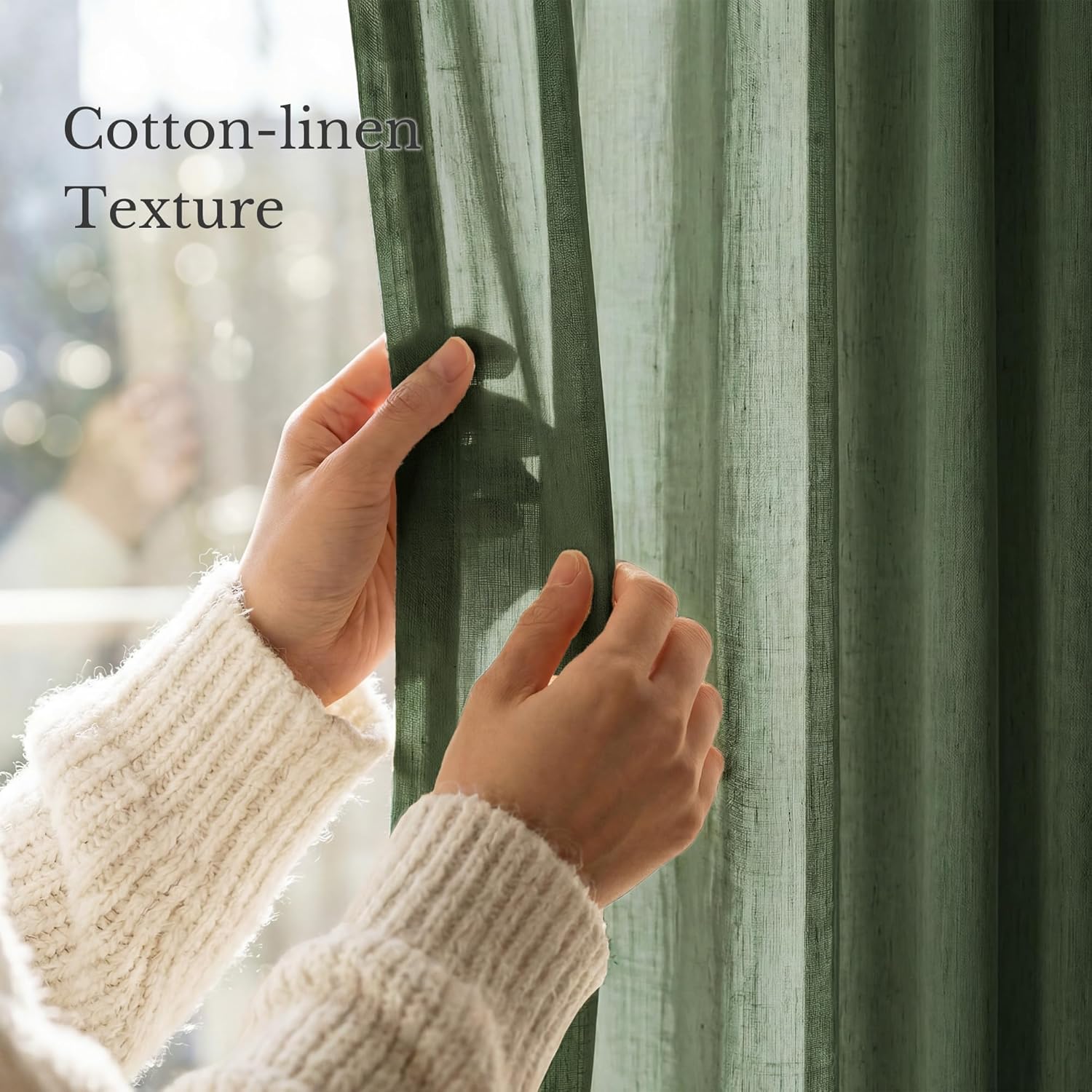 Hands revealing light-filtering olive green cotton-linen textured curtain against a bright window.