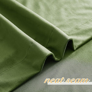 Close-up of olive green fabric showcasing a soft texture and a meticulously neat seam.