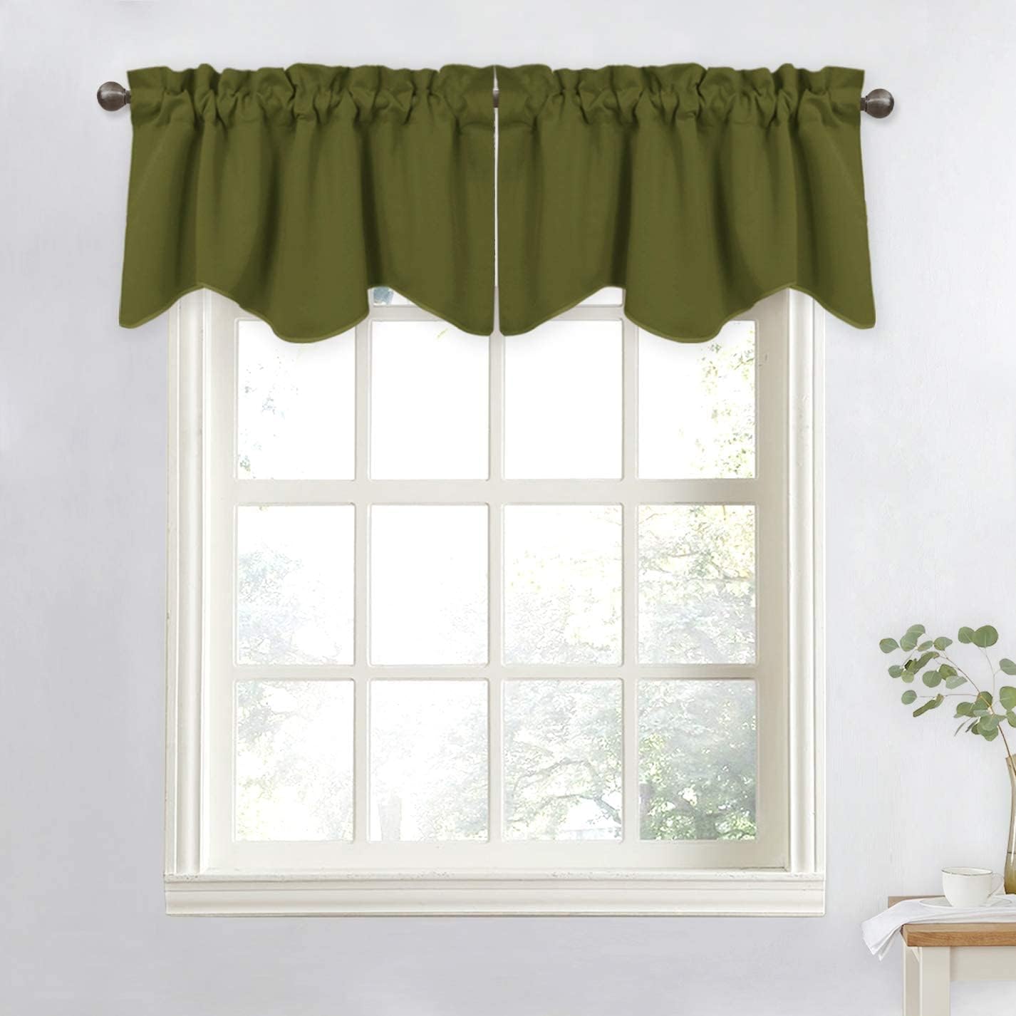 Olive green window valance with a gathered top and scalloped bottom edge, hung on a dark rod over a white window.