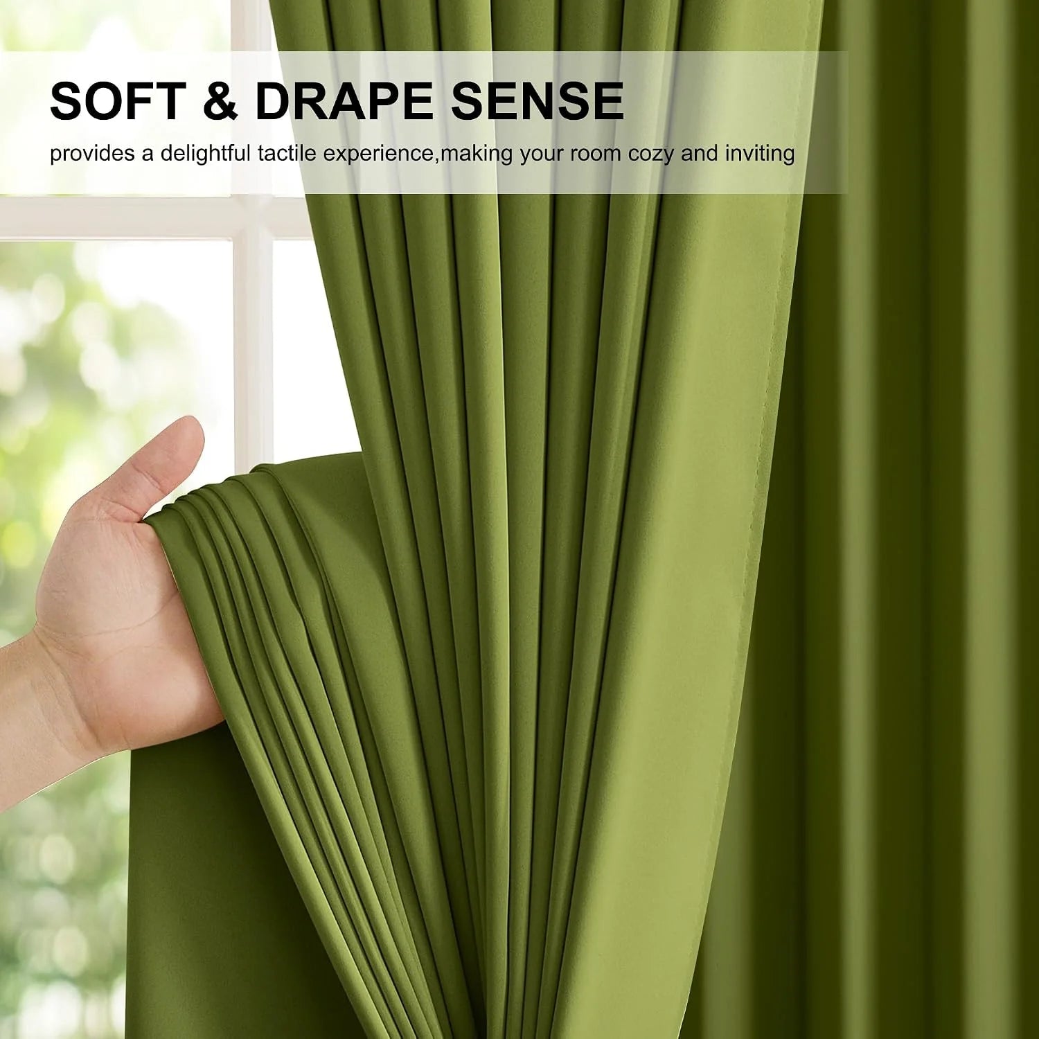 Hand holding olive green curtain fabric to show its soft drape by a bright window
