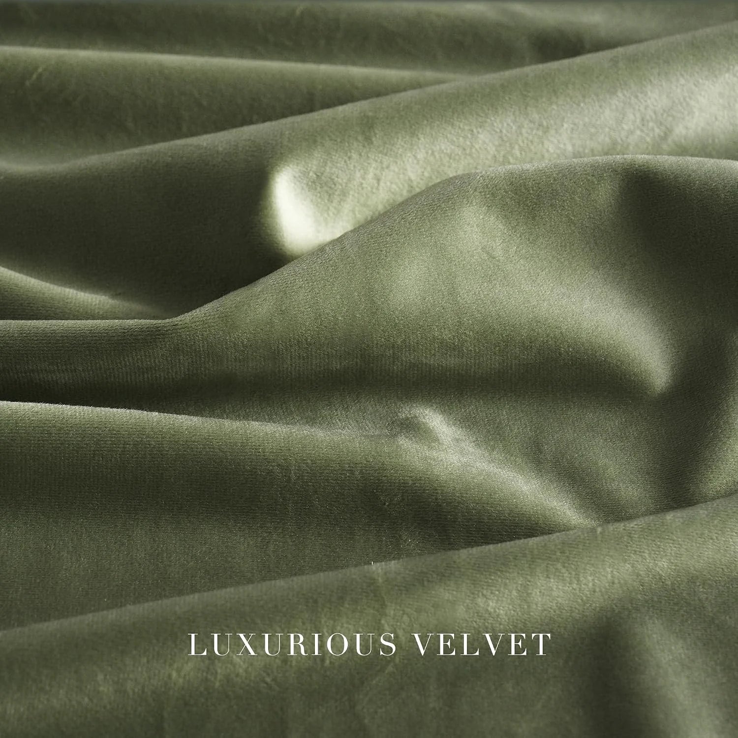 Close-up of olive green velvet fabric with soft folds and a smooth lustrous finish