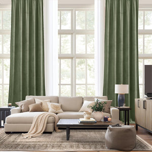 Rich olive green velvet curtains with plush texture hang in a living room, framing large windows.