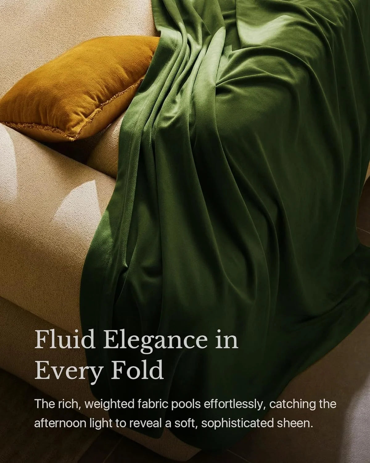 Olive green satin throw draped over a beige armchair with a mustard velvet cushion