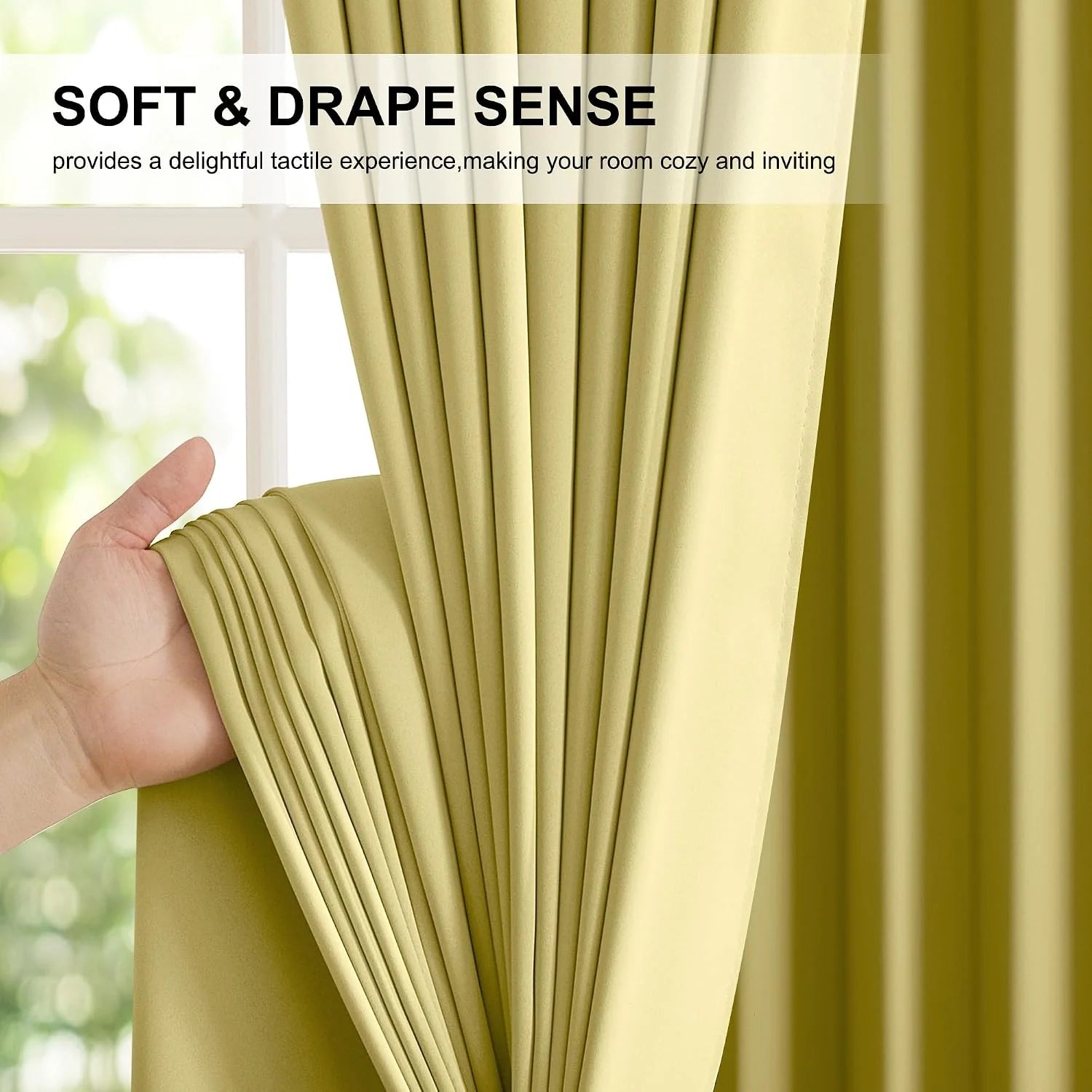 Hand holding soft olive curtain panel with smooth drape beside a bright window