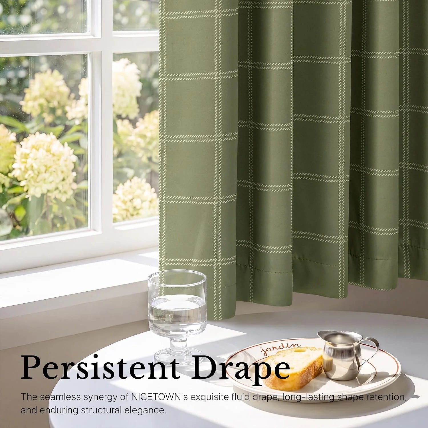 Olive green windowpane curtain panel by a bright white window with soft drape