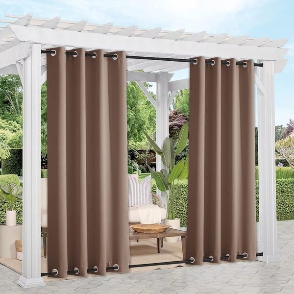 Brown outdoor curtains with silver grommets on a white pergola, providing patio shade and privacy.