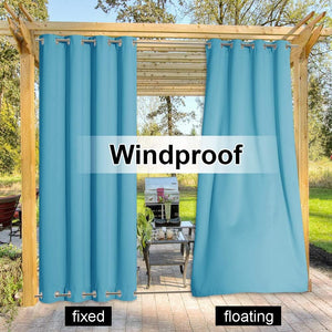 Teal outdoor windproof curtains with grommet top, one fixed to patio and one floating.