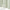 Double layer valance curtain with pale green and white stripes and a natural beige bottom border. Visible woven fabric.