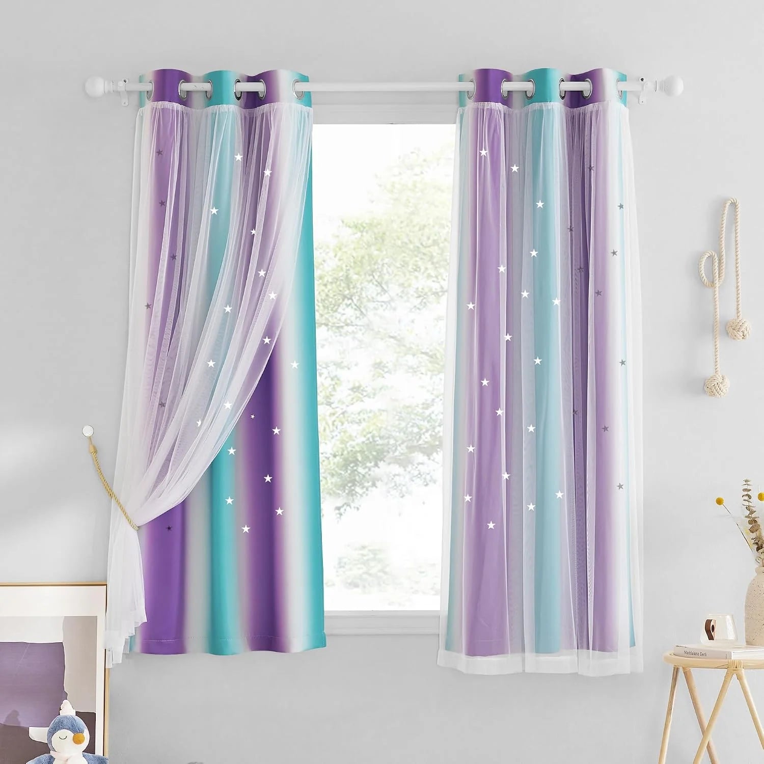 Pastel purple and aqua star curtains with sheer overlay on a white bedroom window