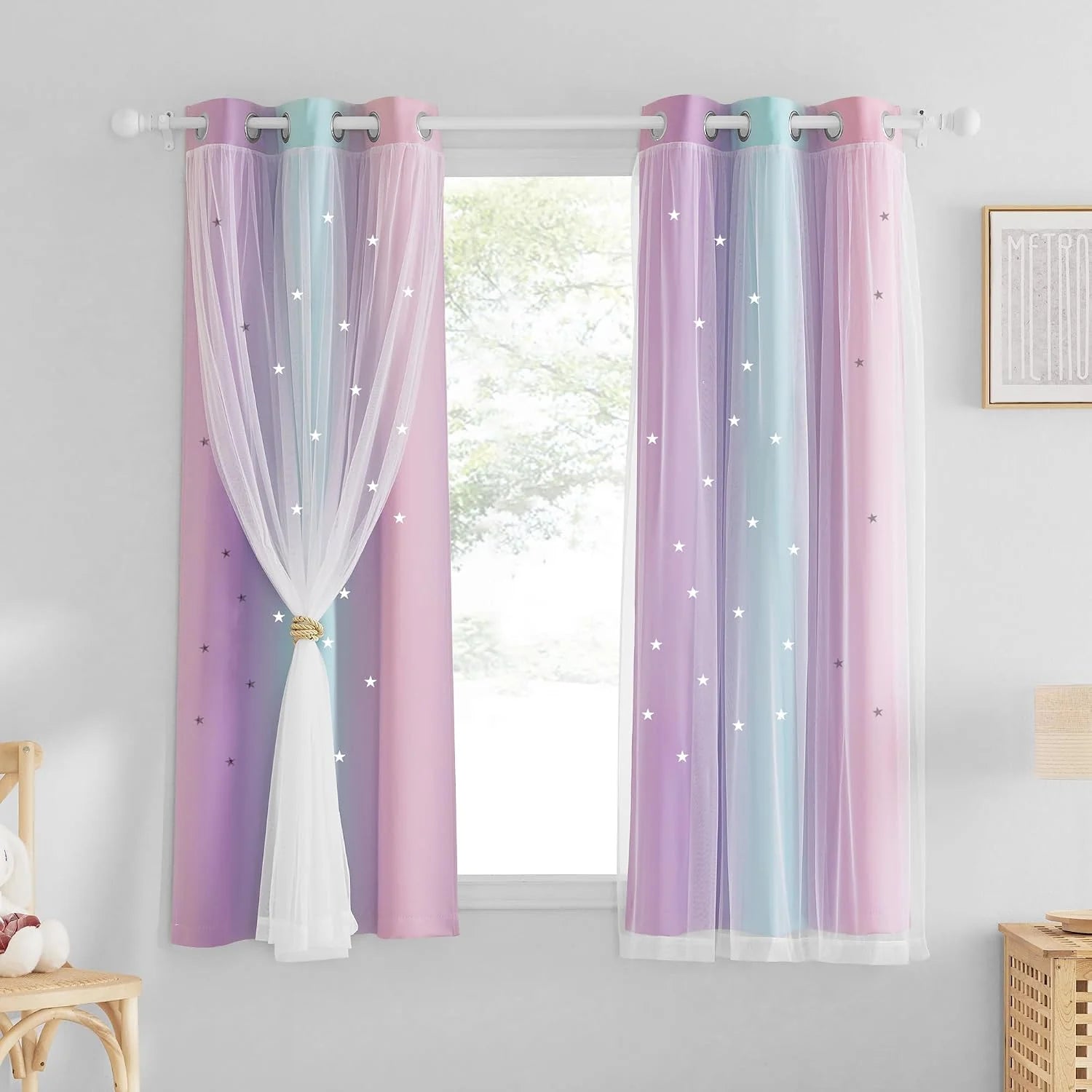 Pastel rainbow curtains with white sheer overlay and star details on a bedroom window