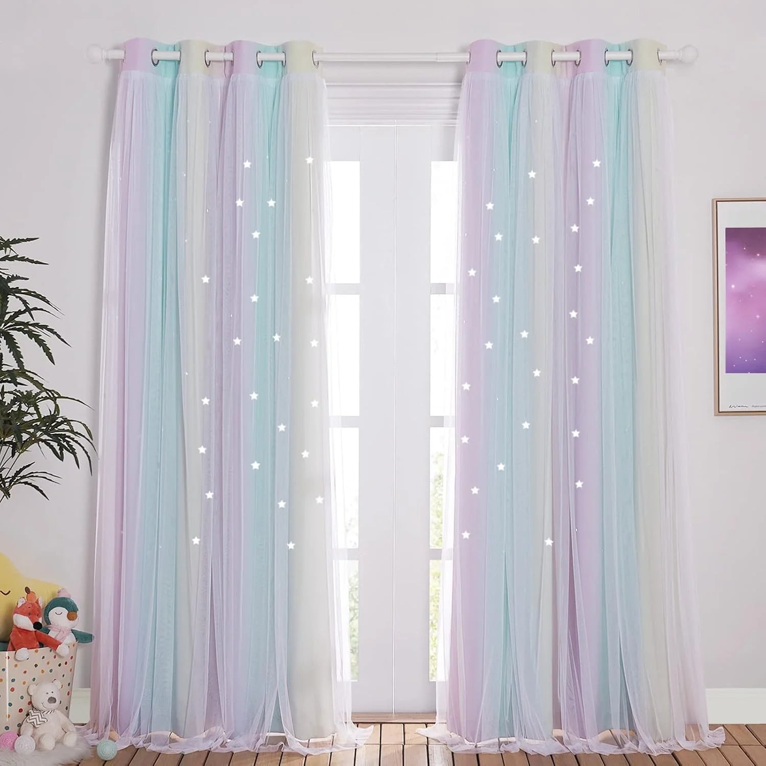 Pastel rainbow sheer tulle curtains with glowing star lights in a kids bedroom