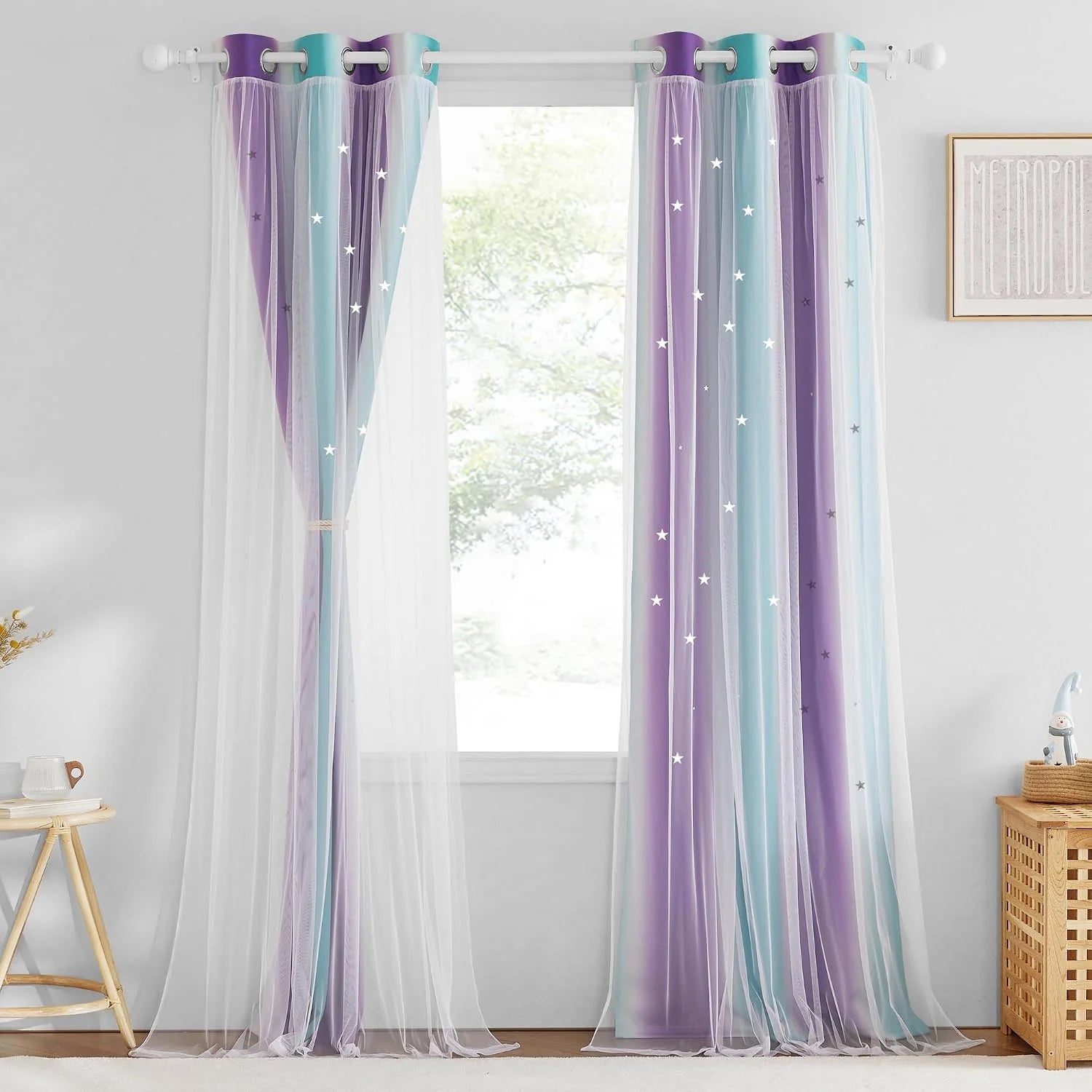 Pastel purple and blue sheer star curtains hanging on a white rod in a bright room