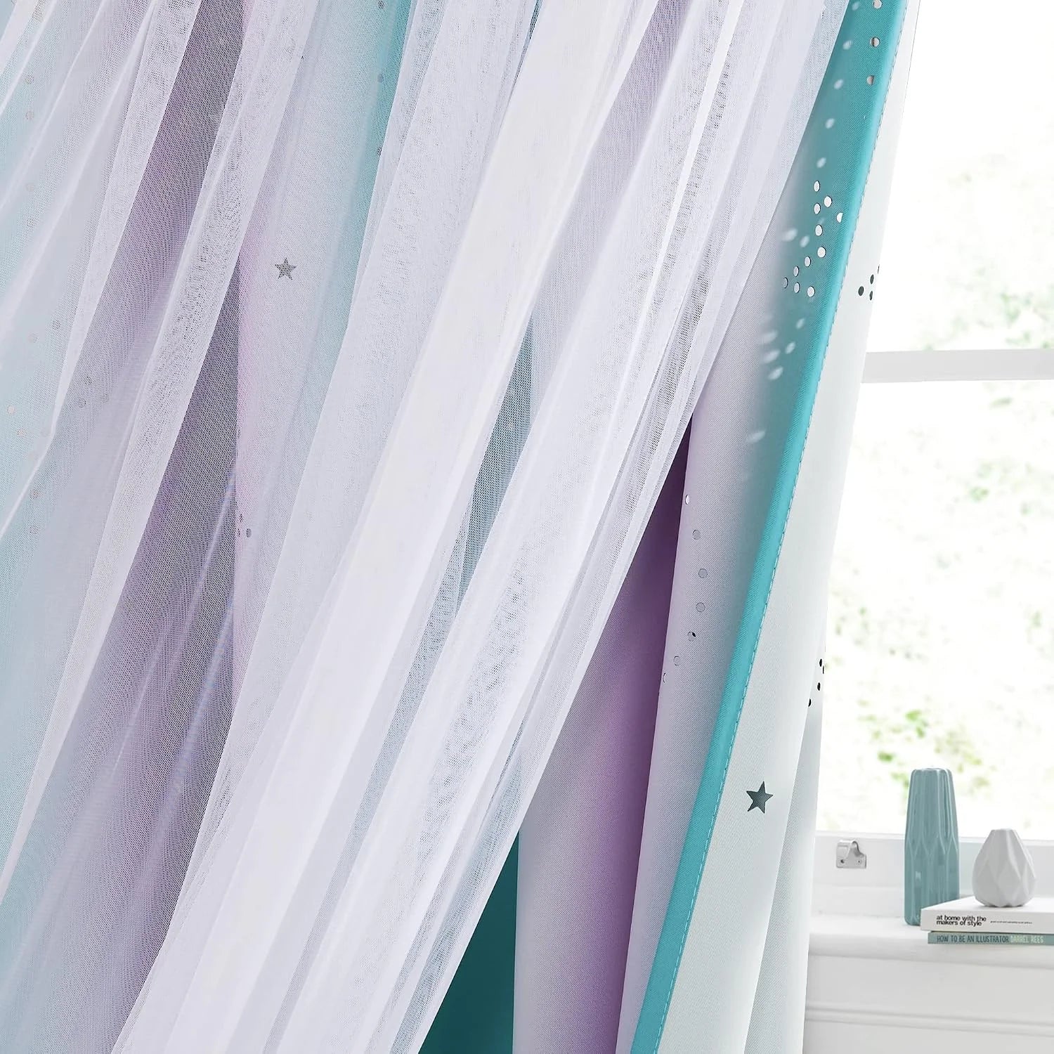 White sheer curtain layered over pastel star cutout drapes by a bright window