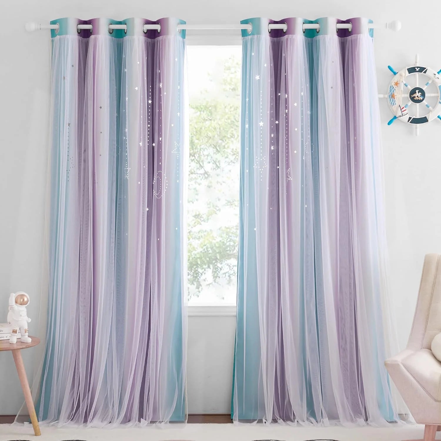 Pastel blue and lavender sheer star curtains with grommet top in a kids room