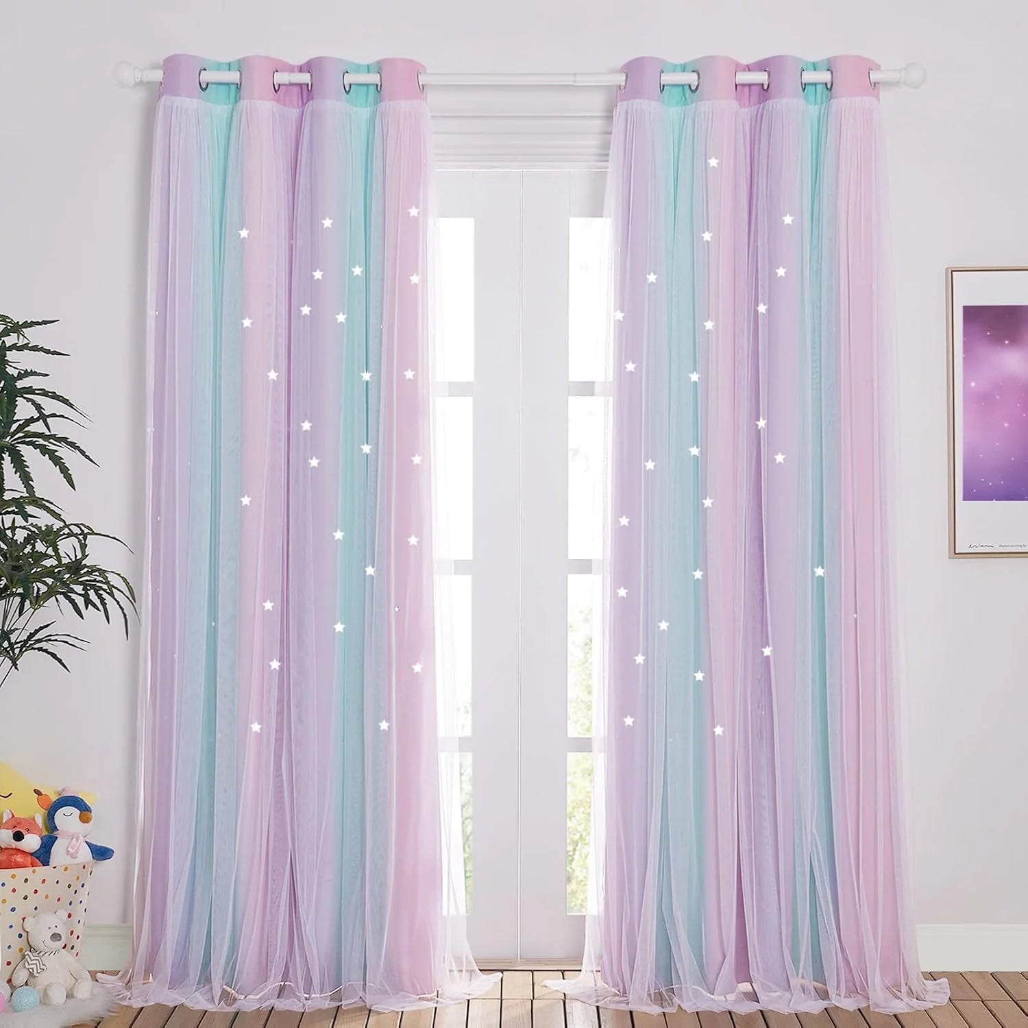 Pastel pink and blue sheer tulle curtains with glowing star details in a kids room