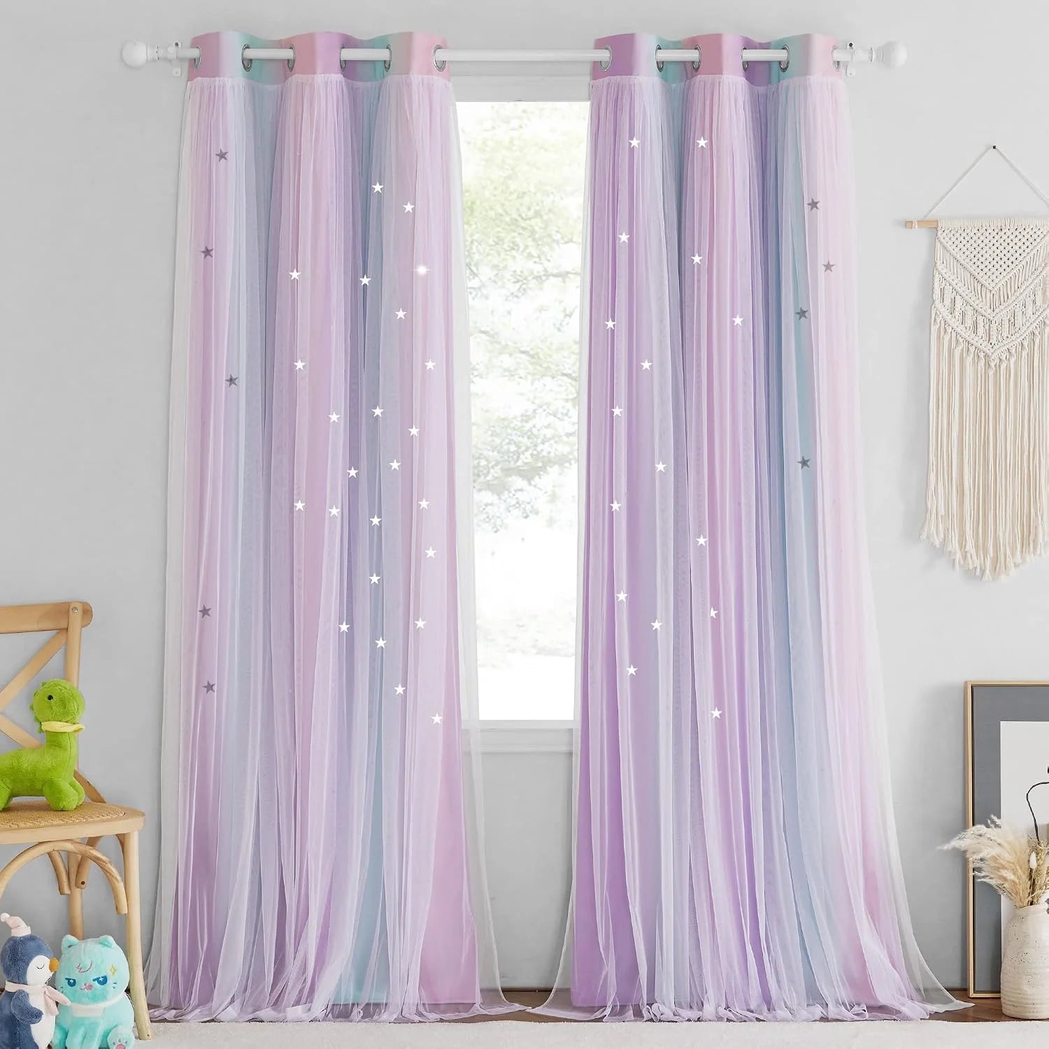 Pastel pink and blue sheer tulle curtains with star cutouts in a kids bedroom