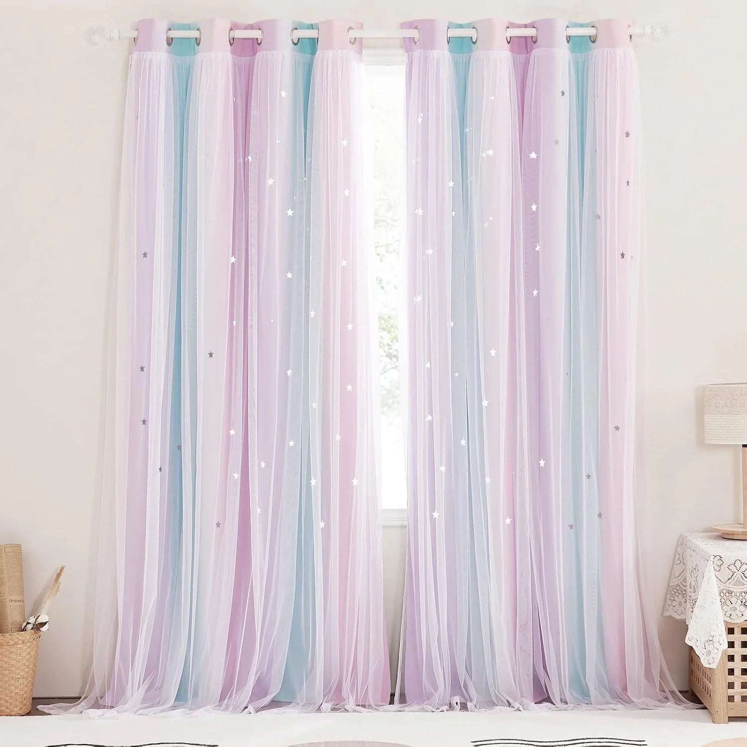 Pastel pink and blue sheer tulle curtains with star details on a window