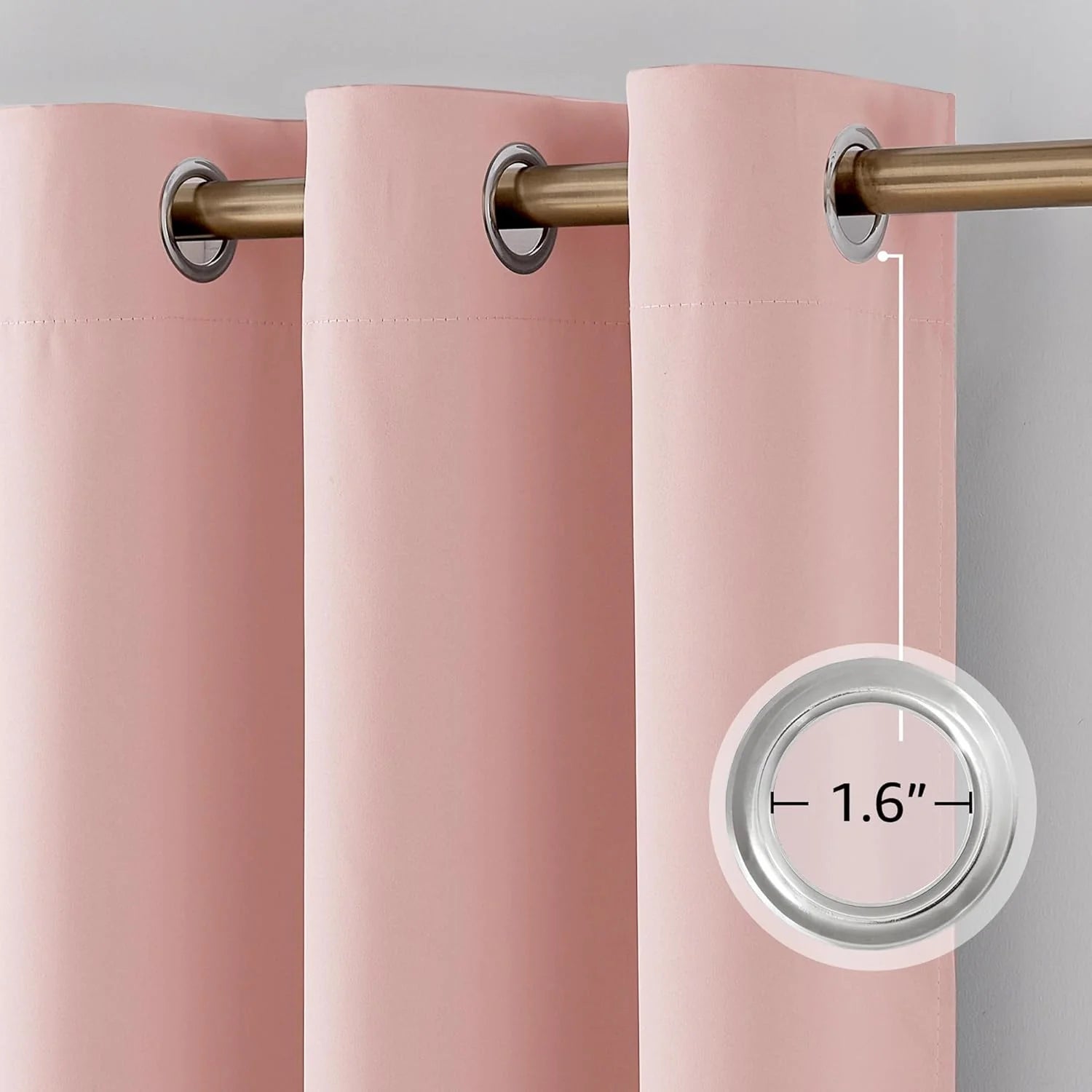 Close-up of pink blackout curtain with 1.6-inch silver grommet and bronze rod