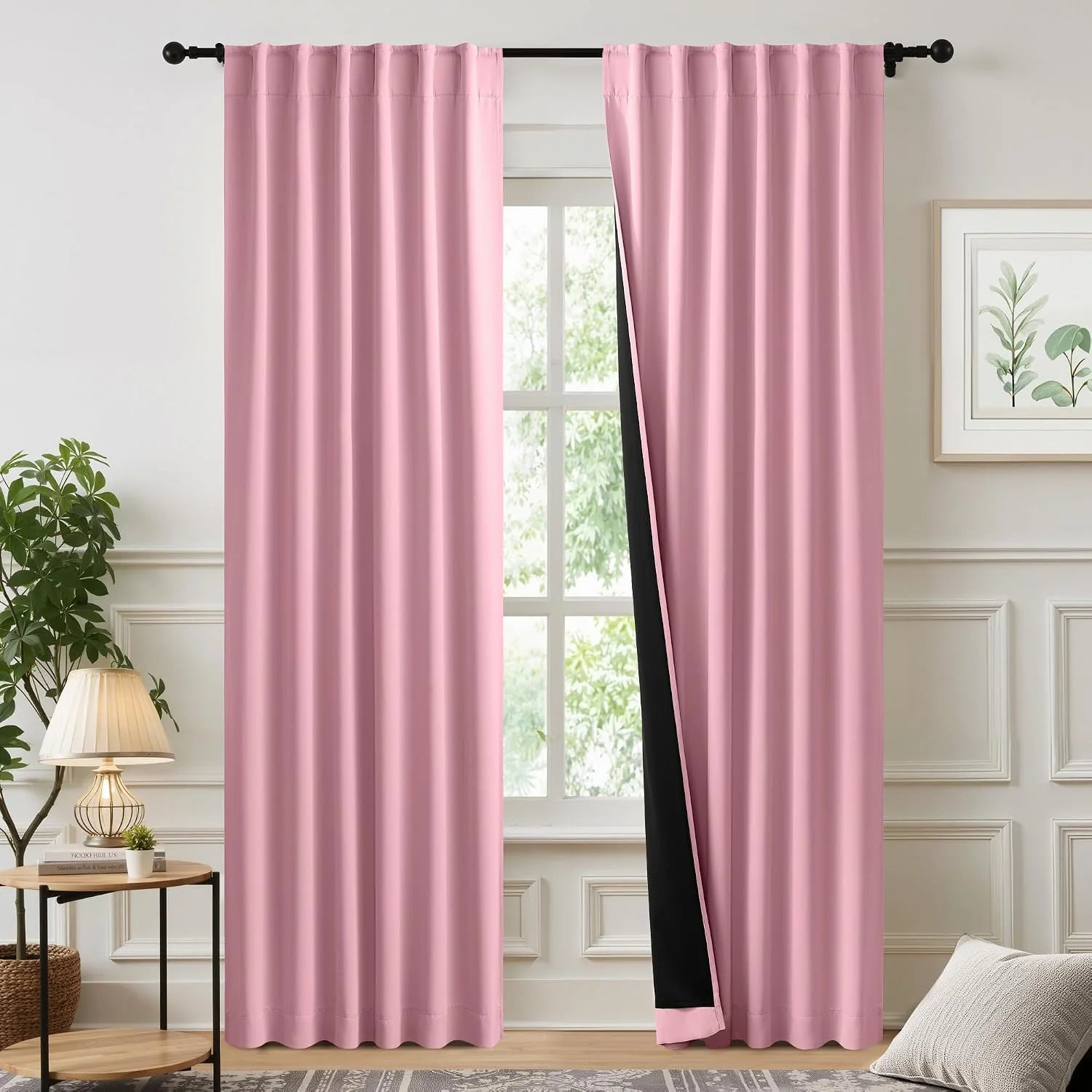Soft pink blackout curtains with rod pocket top hanging in a bright modern room