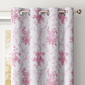 White curtain featuring a pink floral toile pattern with a grommet top, hanging on a gold rod.