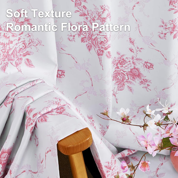 Soft white fabric draped over a wooden chair arm, featuring a romantic pink floral toile pattern.