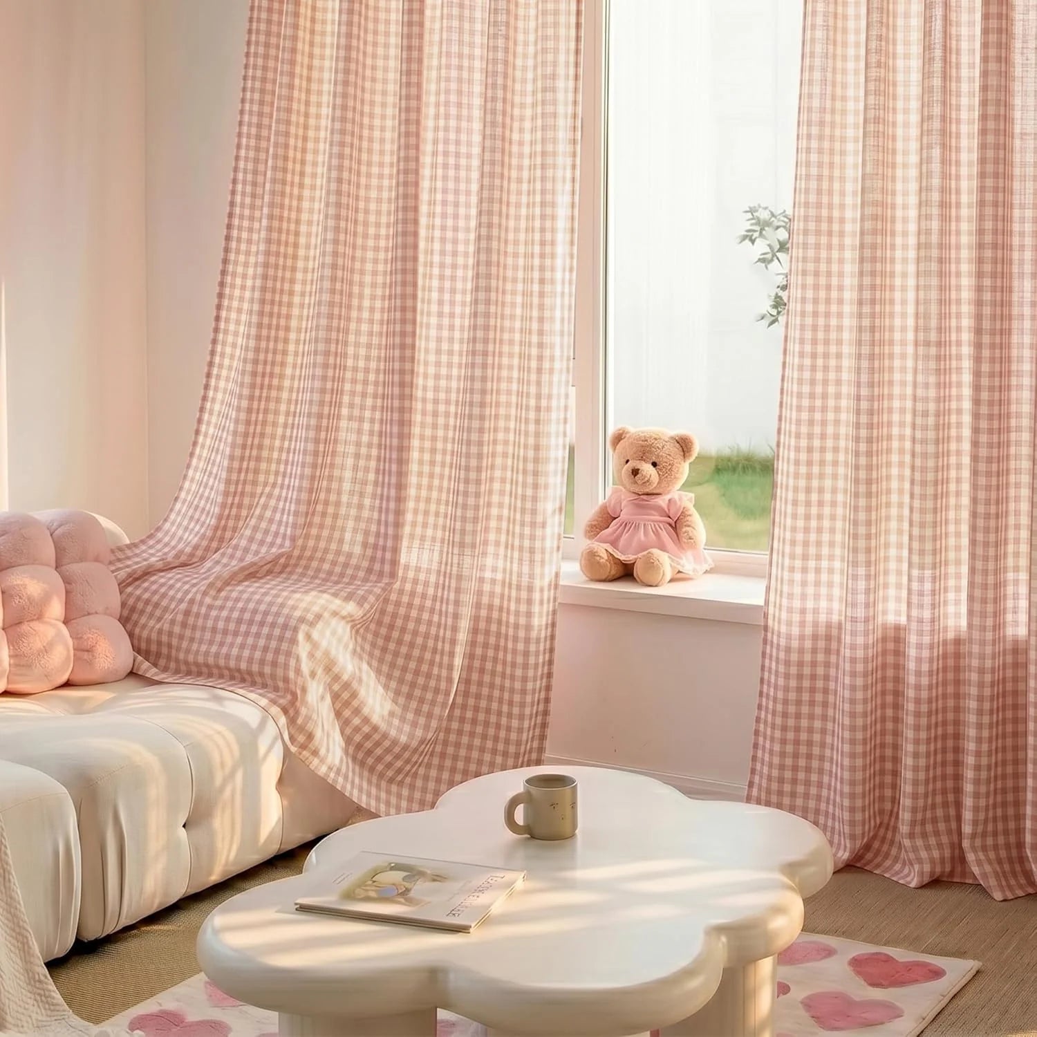 Pink gingham sheer curtains in a cozy room with a white sofa, cloud coffee table, and teddy bear.