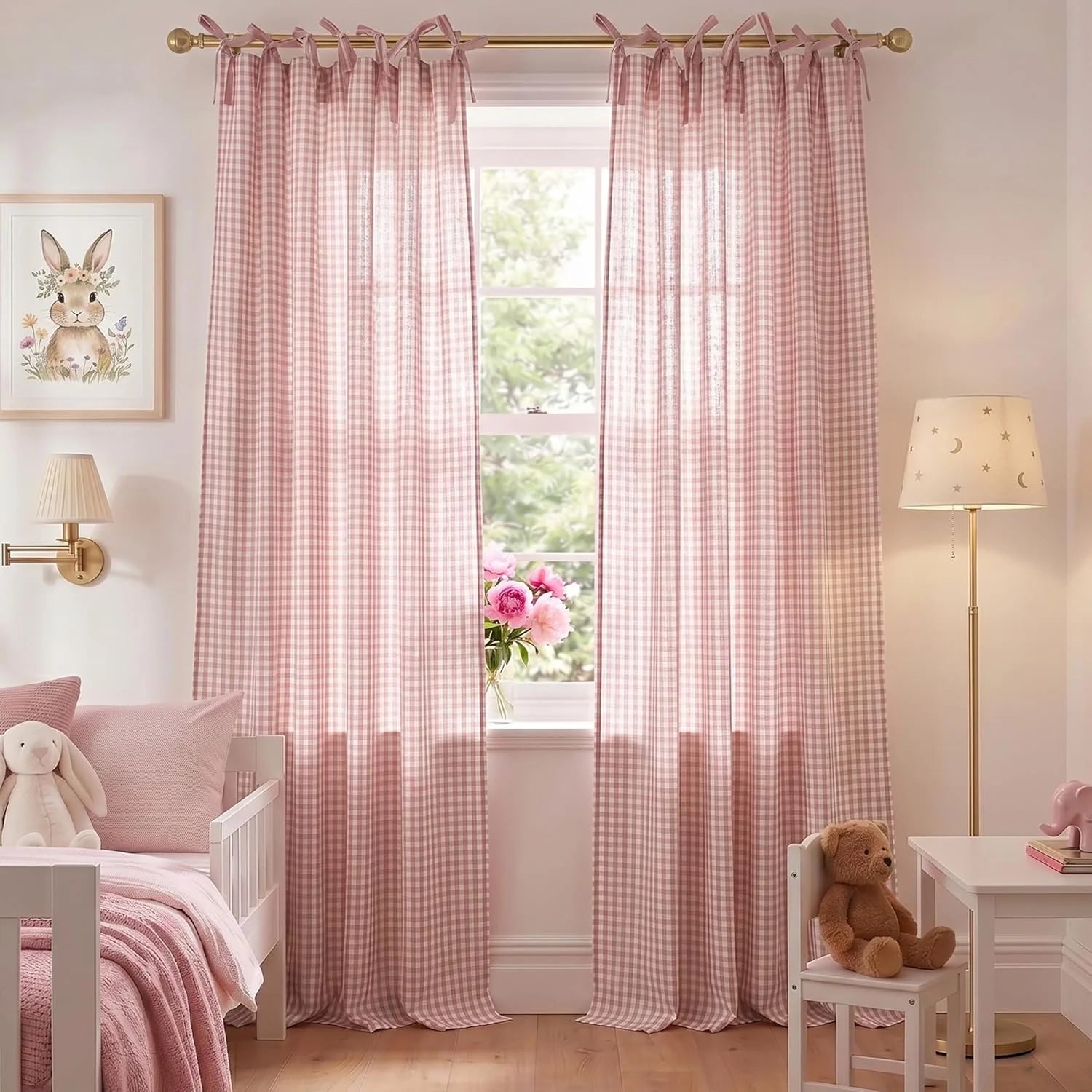 Pink gingham tie-top curtains in a child's bedroom with a white bed and bunny decor