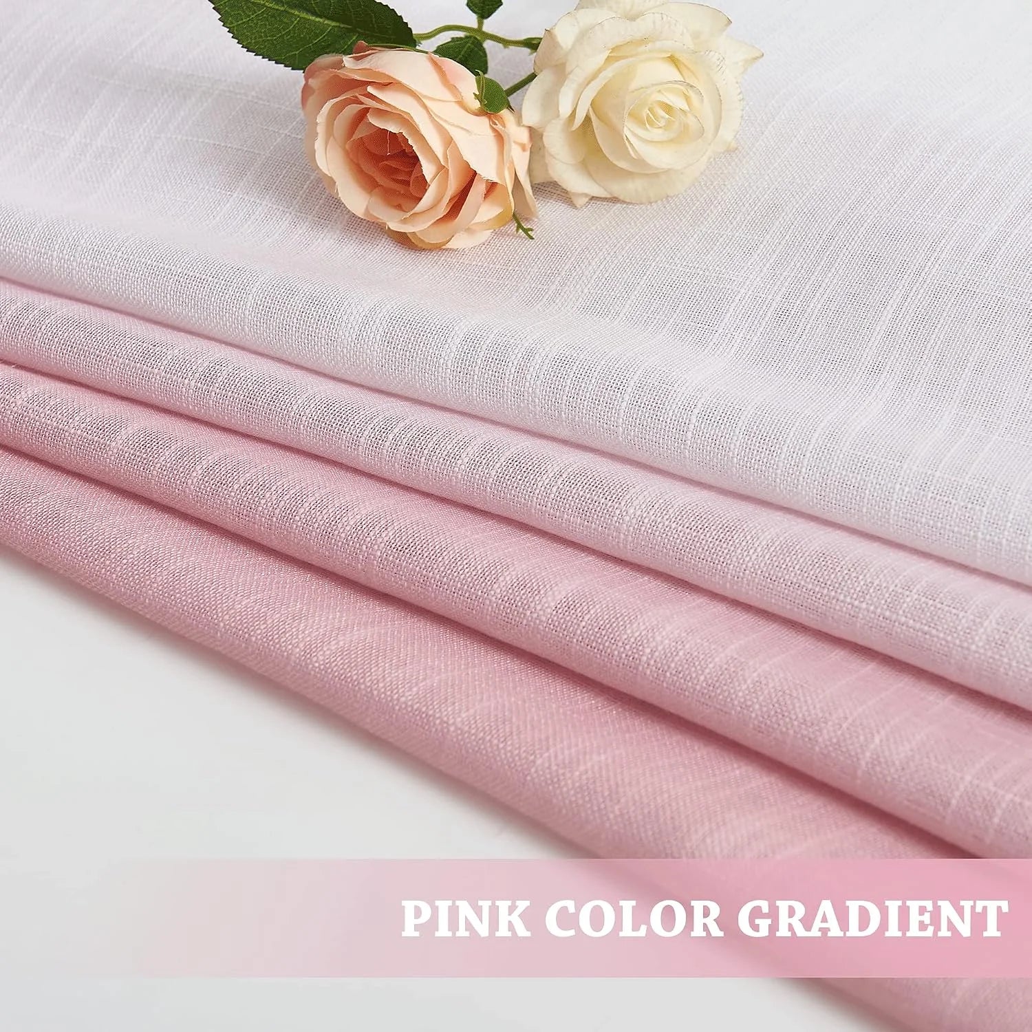Pink gradient sheer linen fabric folded in layers with two roses on top