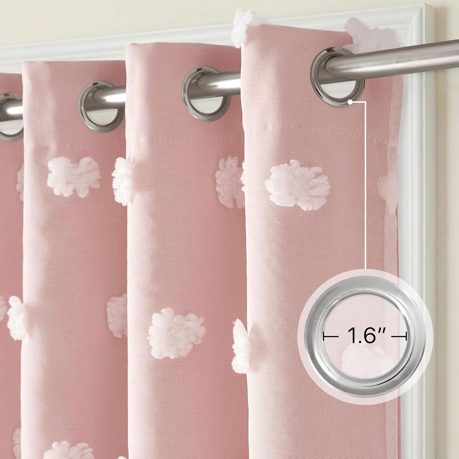 Light pink curtains featuring white fluffy pom-poms and silver grommet tops. One grommet is 1.6 inches.